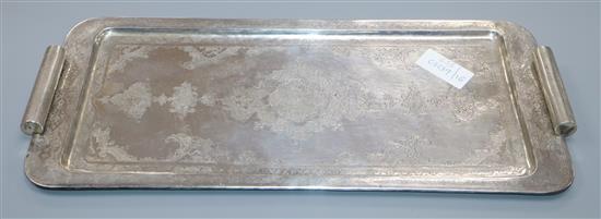 A Persian engraved white metal rectangular two handled tray, 996 grams.